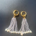 Long crystal fringe earrings with mini pearls plated in 18k gold.